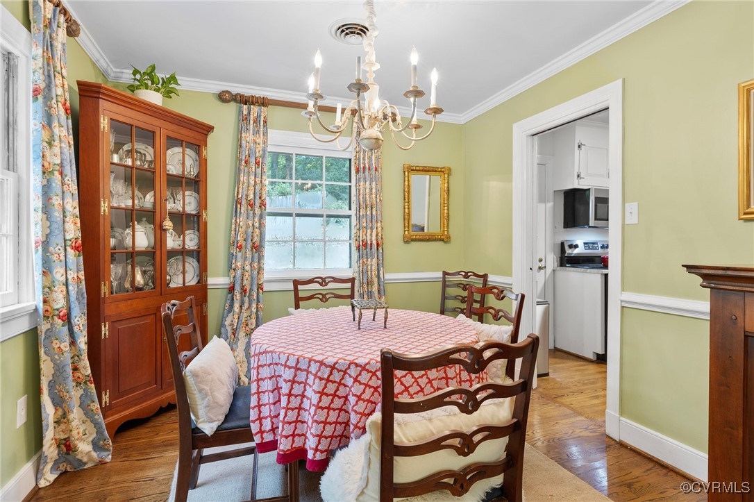 4233 Waumsetta Road Richmond, VA 23235 - Photo 5 of 32 a view of a dining room with furniture and chandelier