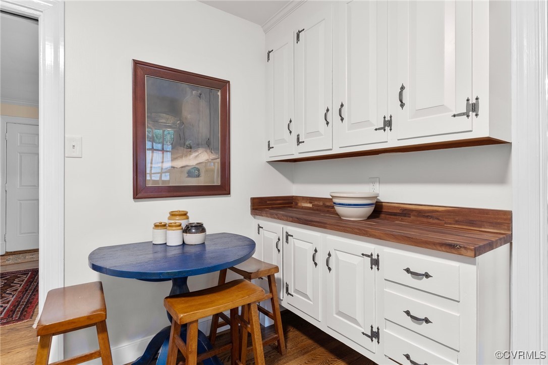 4233 Waumsetta Road Richmond, VA 23235 - Photo 7 of 32 a kitchen with stainless steel appliances a white cabinets and chairs