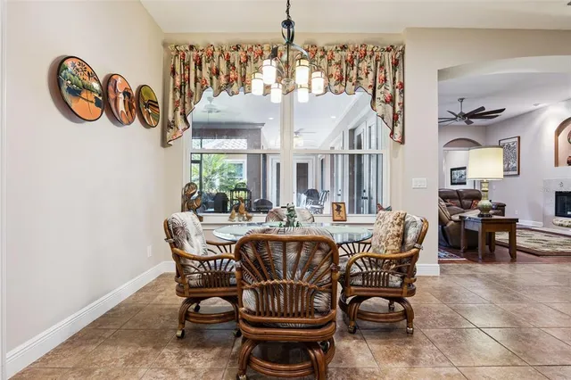 a living room with furniture fireplace and a large window