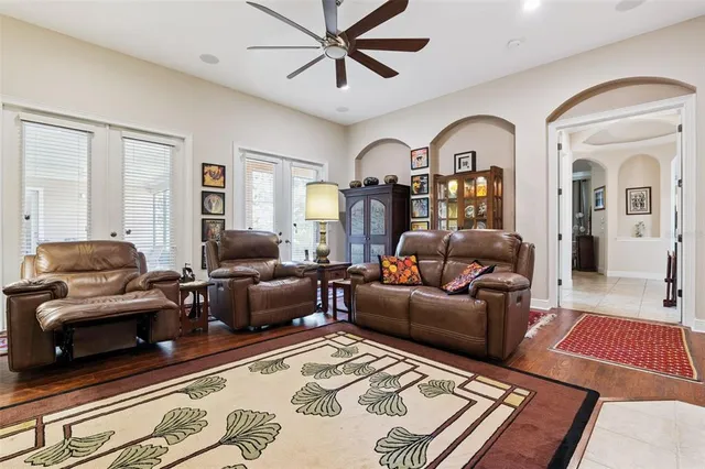 a living room with furniture ceiling fan and a rug