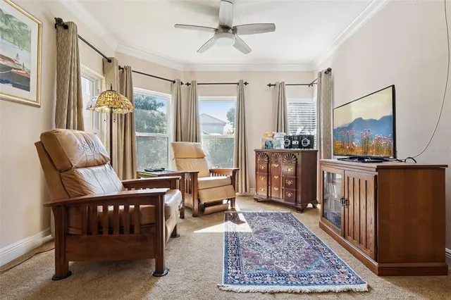 a bedroom with bed and large windows