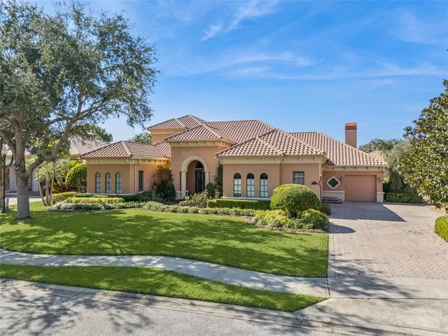a large house with a big yard and large trees