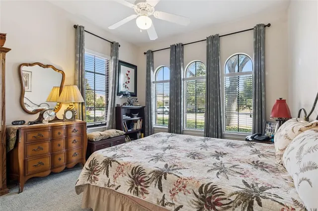 a room with a table chairs and a refrigerator