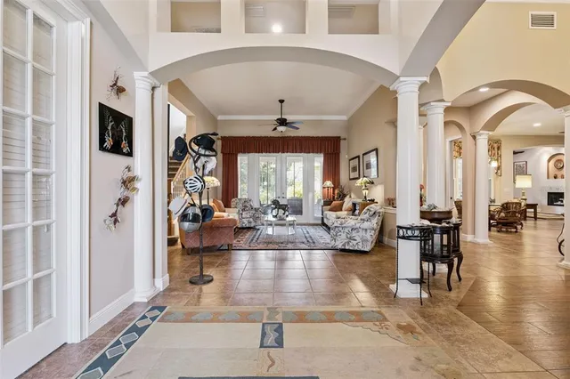 a living room with fireplace furniture and a large window