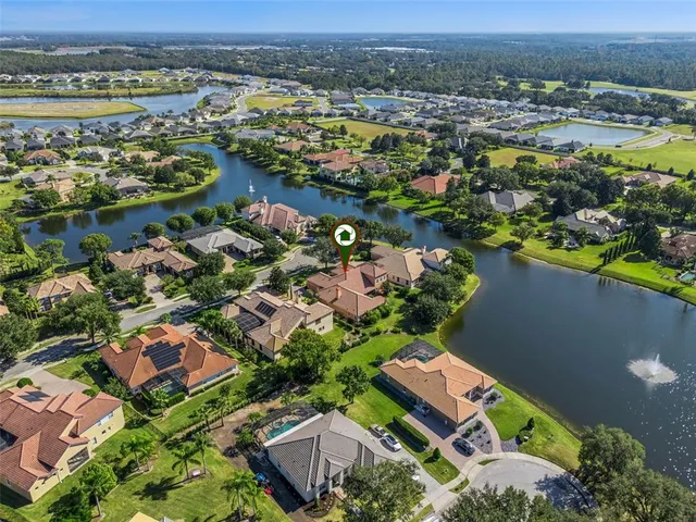 an aerial view of lake and residential houses with outdoor space