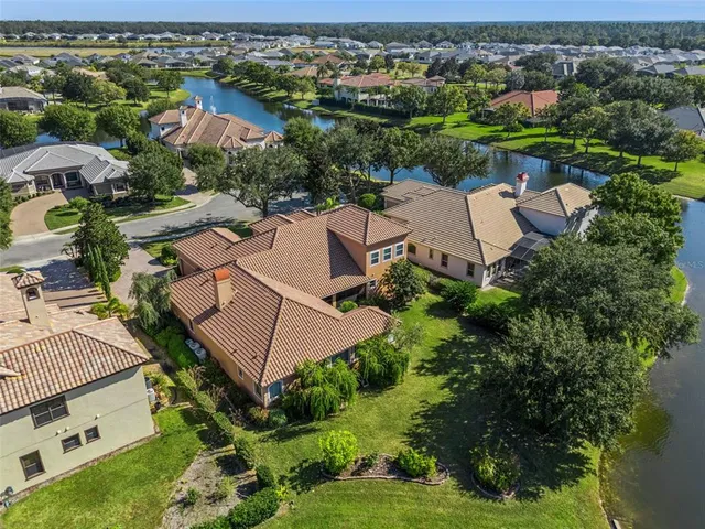 an aerial view of a house with a lake view