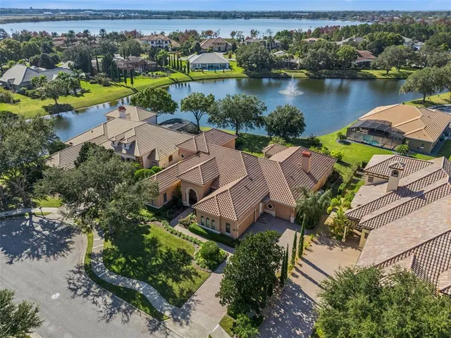 an aerial view of a house with outdoor space and lake view