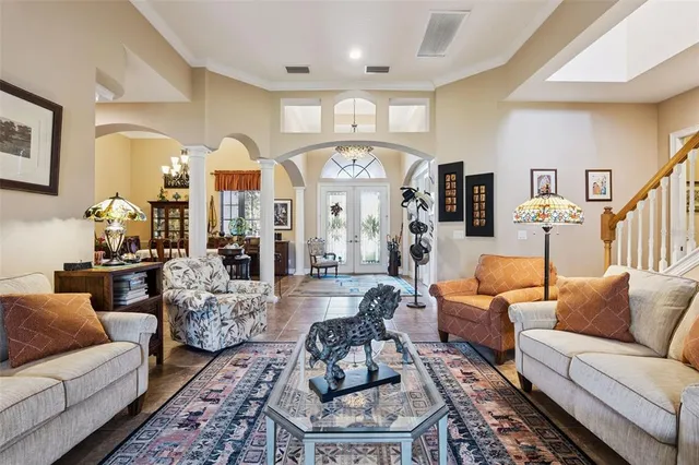 a living room with furniture fireplace and a large window