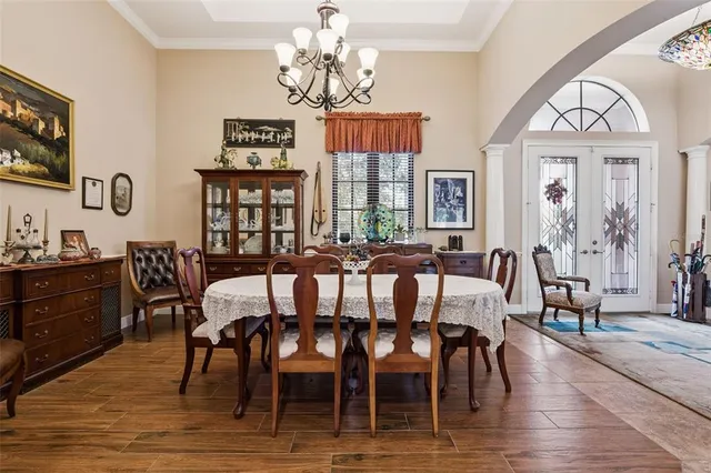 a view of a dining room with furniture wooden floor and chandelier