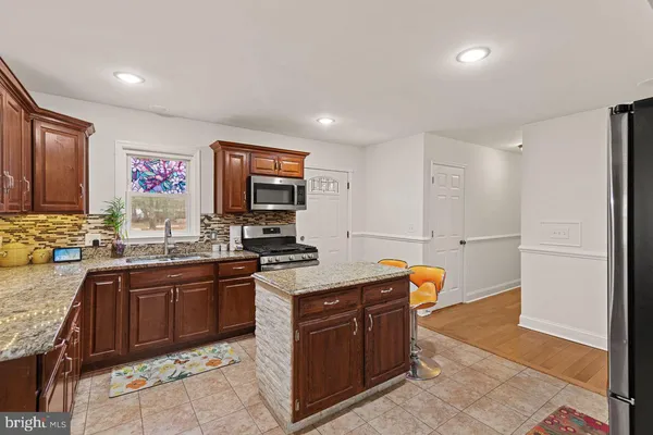 a view of a dining room with furniture a chandelier and wooden floor