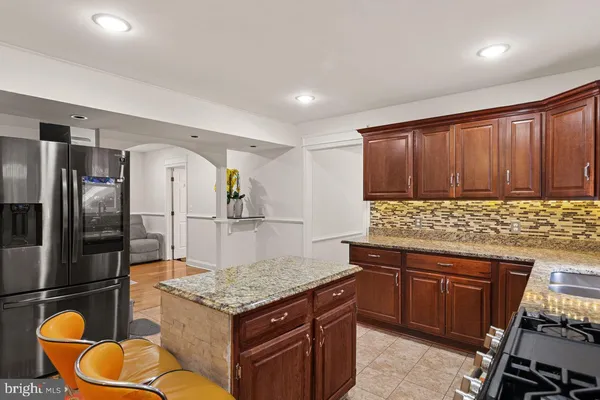 a bathroom with a granite countertop sink a mirror and a shower