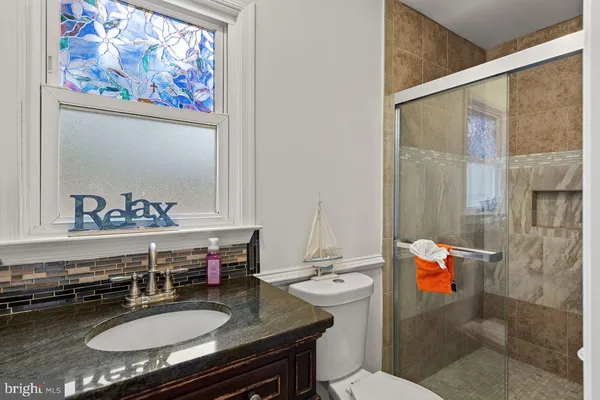 a bedroom with furniture and a flat screen tv