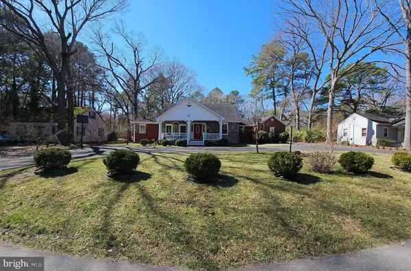 a view of water fountain with large trees