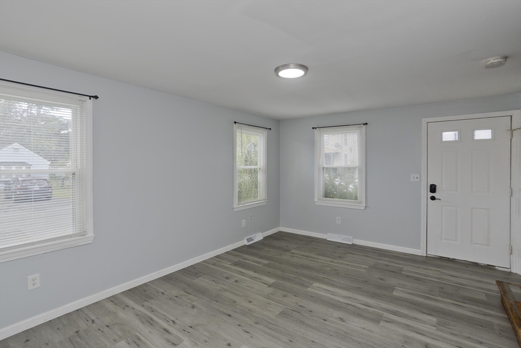 37-39 Porter Street Springfield, MA 01104 - Photo 11 of 40 an empty room with wooden floor and windows