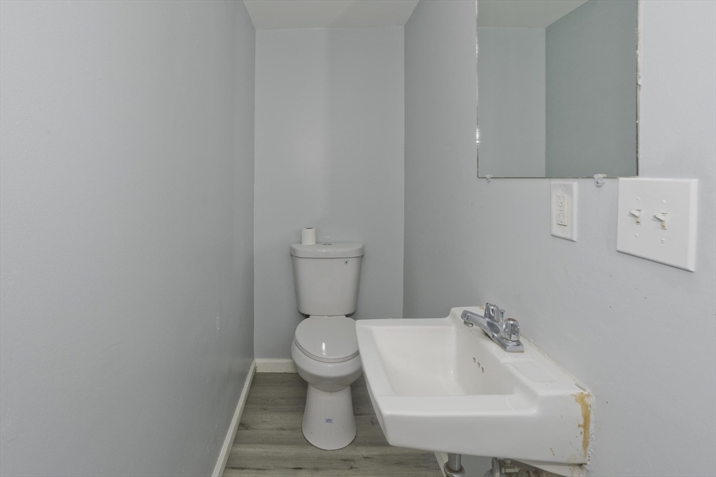 37-39 Porter Street Springfield, MA 01104 - Photo 13 of 40 a white toilet sitting next to a white sink