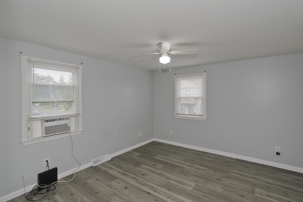37-39 Porter Street Springfield, MA 01104 - Photo 15 of 40 a view of an empty room with a window and wooden floor