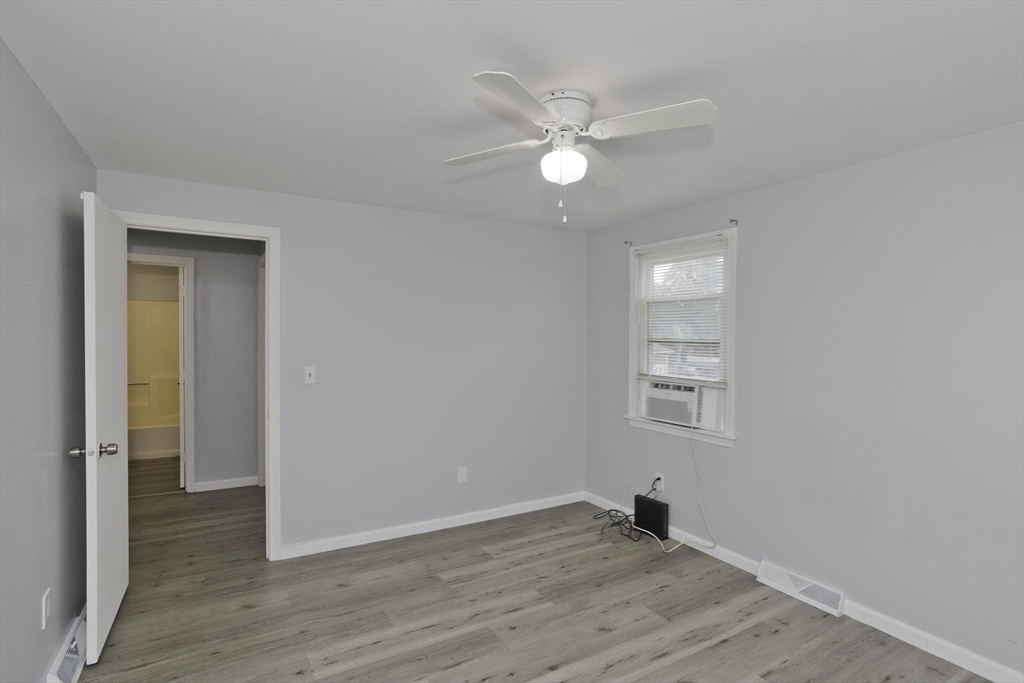 37-39 Porter Street Springfield, MA 01104 - Photo 17 of 40 a view of empty room with wooden floor and fan