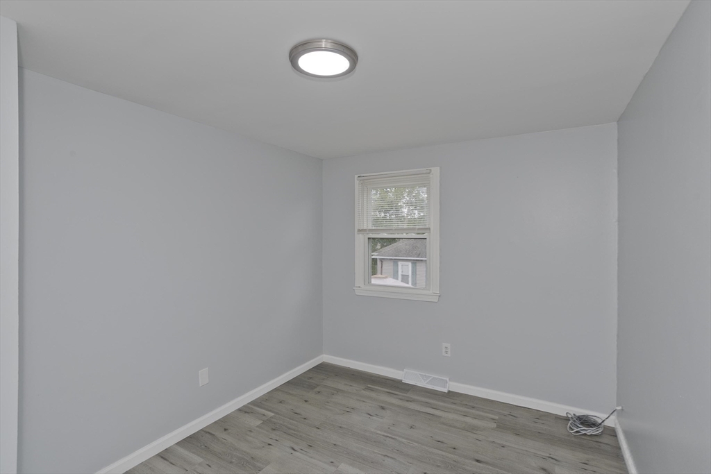 37-39 Porter Street Springfield, MA 01104 - Photo 22 of 40 wooden floor in an empty room with a window