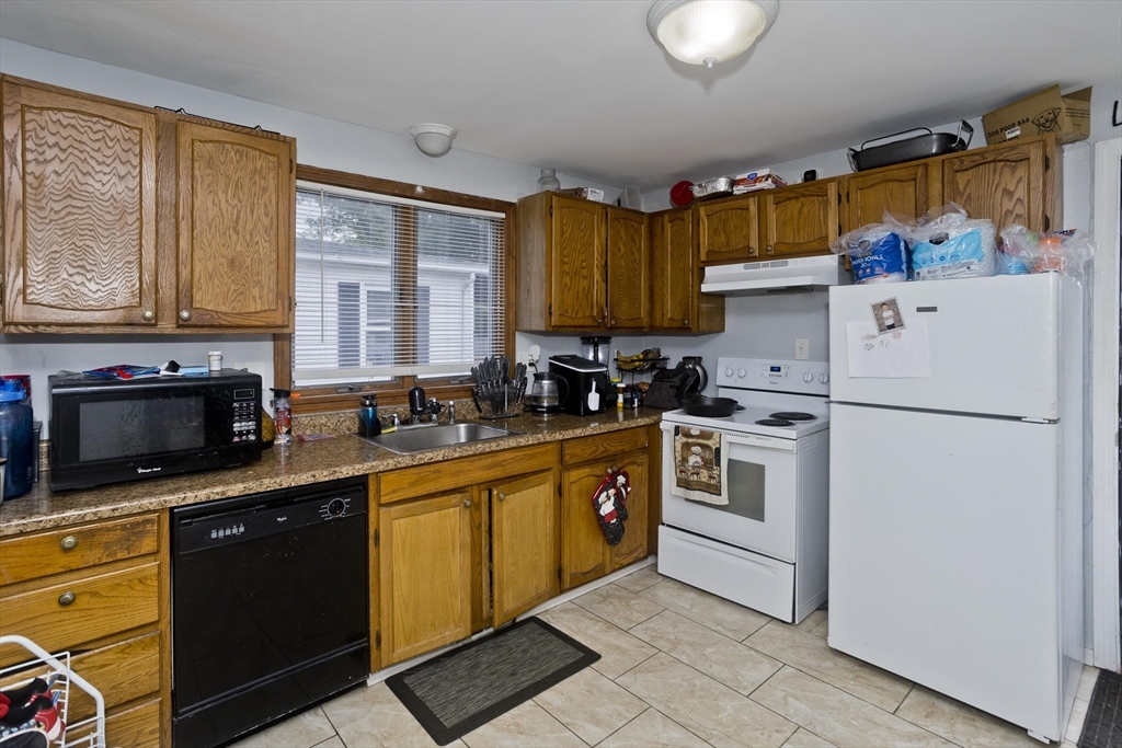 37-39 Porter Street Springfield, MA 01104 - Photo 23 of 40 a kitchen with granite countertop a sink stainless steel appliances and cabinets