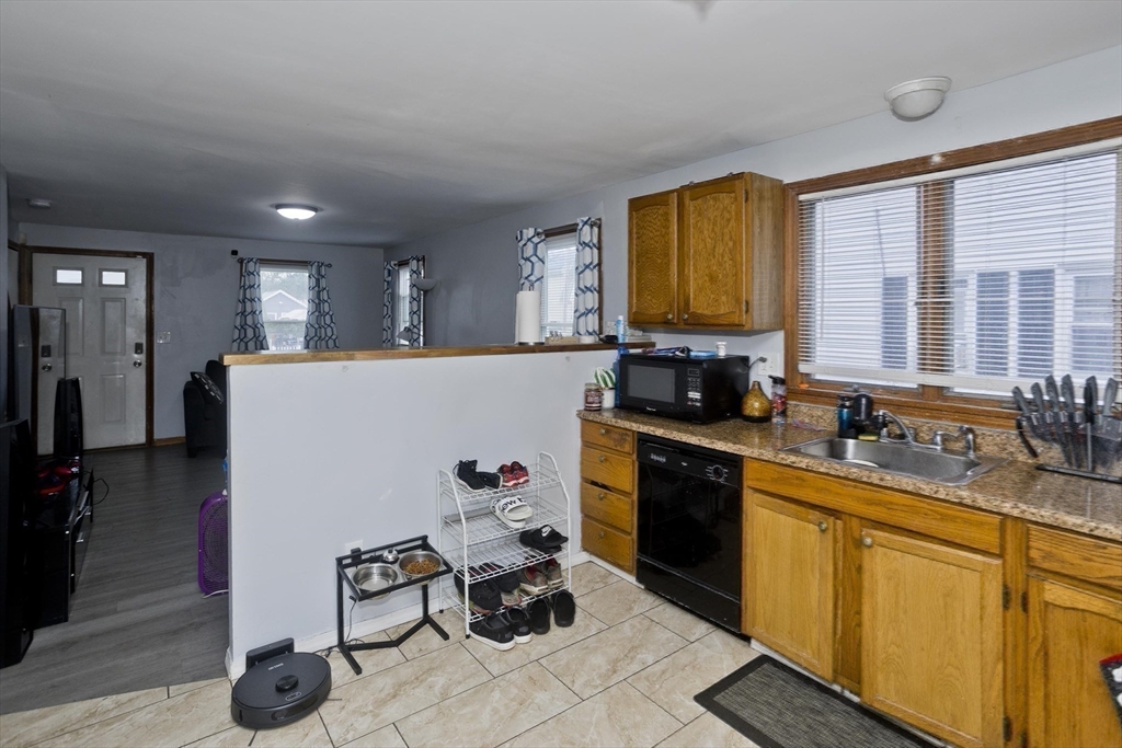 37-39 Porter Street Springfield, MA 01104 - Photo 25 of 40 a kitchen with granite countertop cabinets a sink a window and stainless steel appliances