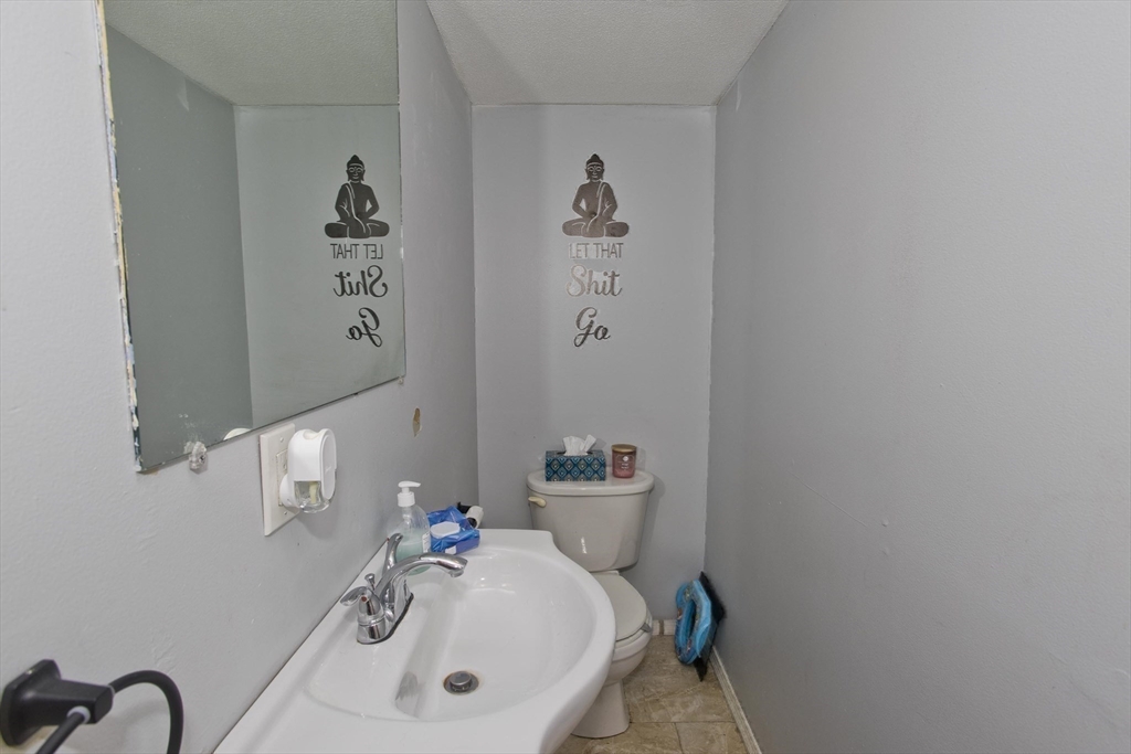 37-39 Porter Street Springfield, MA 01104 - Photo 28 of 40 a bathroom with a sink vanity and toilet