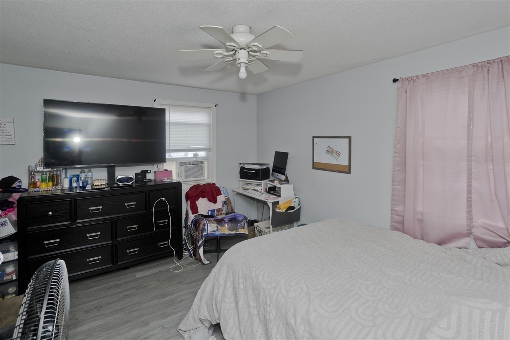 37-39 Porter Street Springfield, MA 01104 - Photo 29 of 40 a bedroom with furniture and a flat screen tv