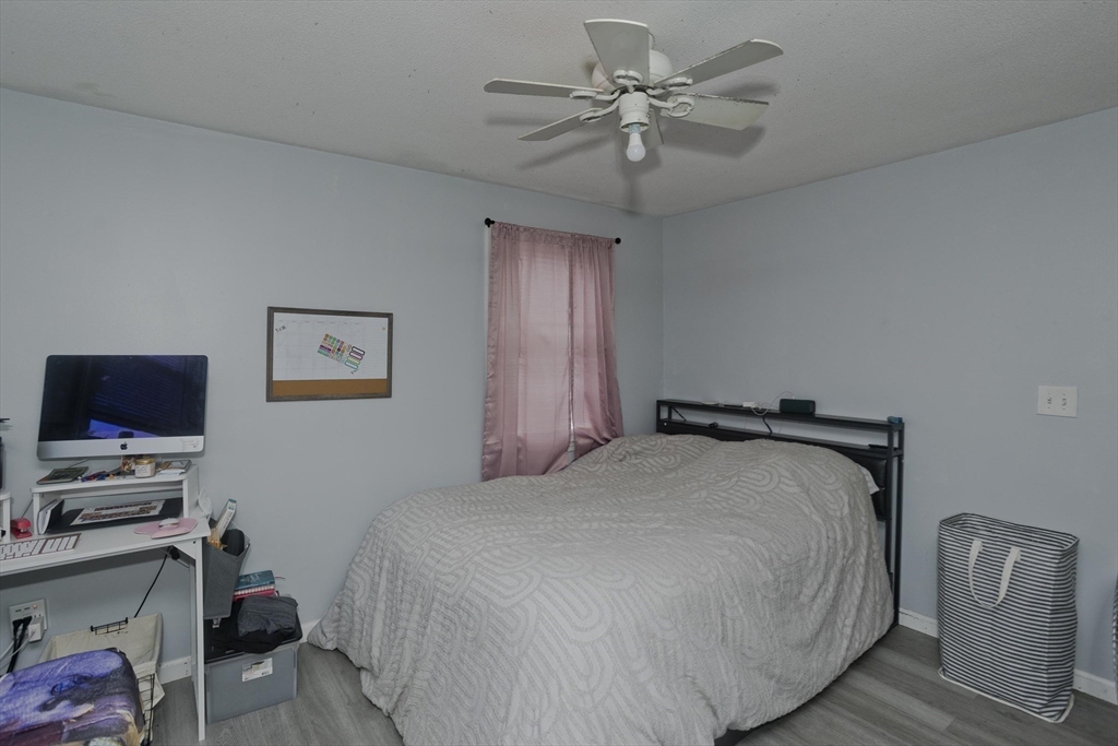37-39 Porter Street Springfield, MA 01104 - Photo 30 of 40 a bedroom with a bed and a flat screen tv