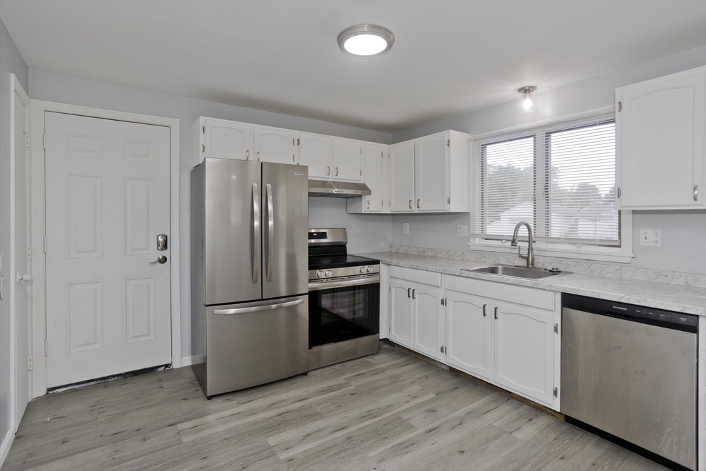37-39 Porter Street Springfield, MA 01104 - Photo 3 of 40 a kitchen with stainless steel appliances granite countertop a refrigerator and a sink