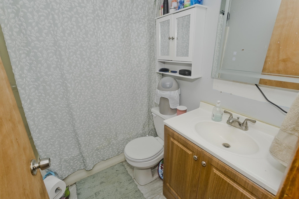 37-39 Porter Street Springfield, MA 01104 - Photo 32 of 40 a bathroom with a sink a toilet and a mirror