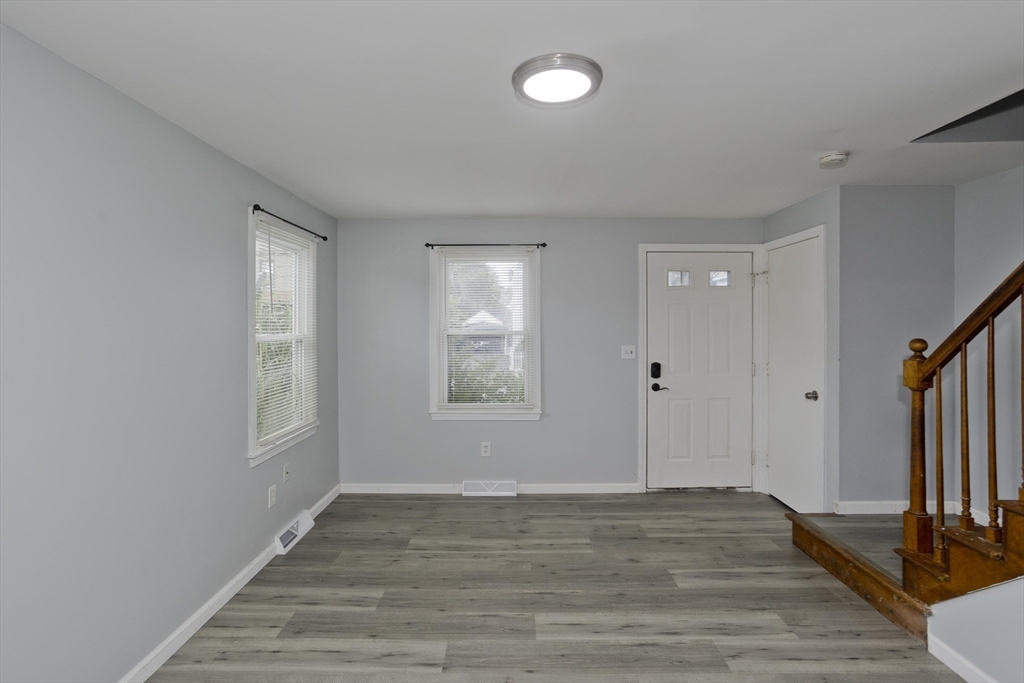 37-39 Porter Street Springfield, MA 01104 - Photo 4 of 40 a view of an empty room with wooden floor and a window