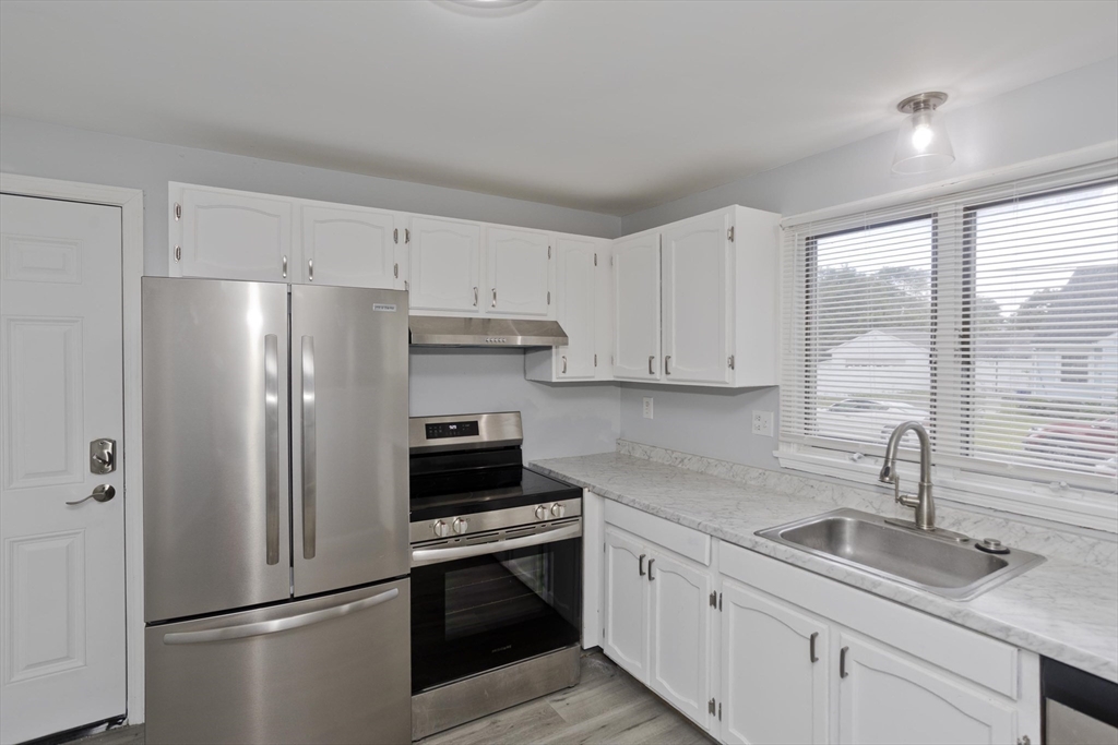 37-39 Porter Street Springfield, MA 01104 - Photo 8 of 40 a kitchen with stainless steel appliances granite countertop a refrigerator sink and stove