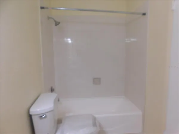 a bathroom with a bathtub and toilet