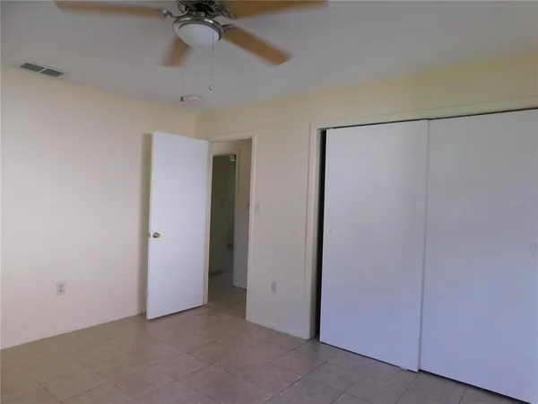 a view of a room with a ceiling fan