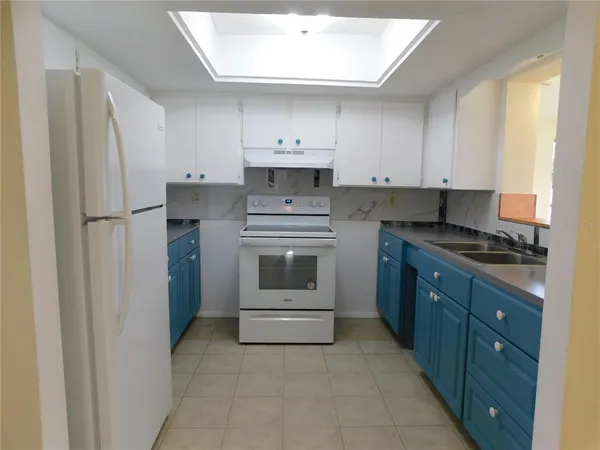 a kitchen with a stove sink and refrigerator