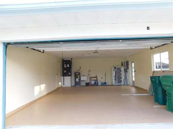 a view of a hallway to a livingroom with furniture
