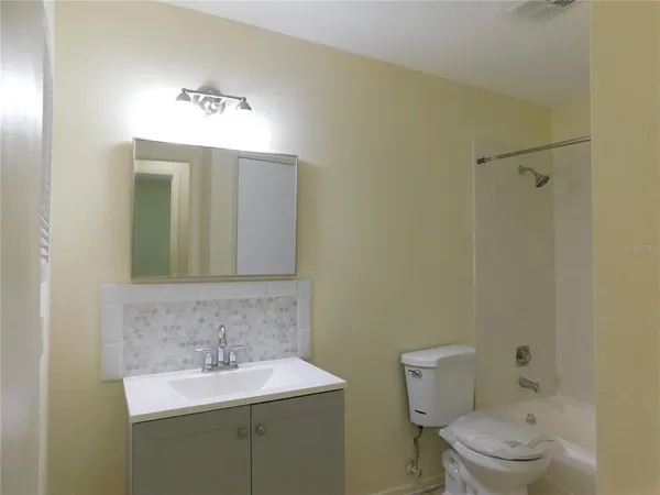a bathroom with a sink toilet and mirror