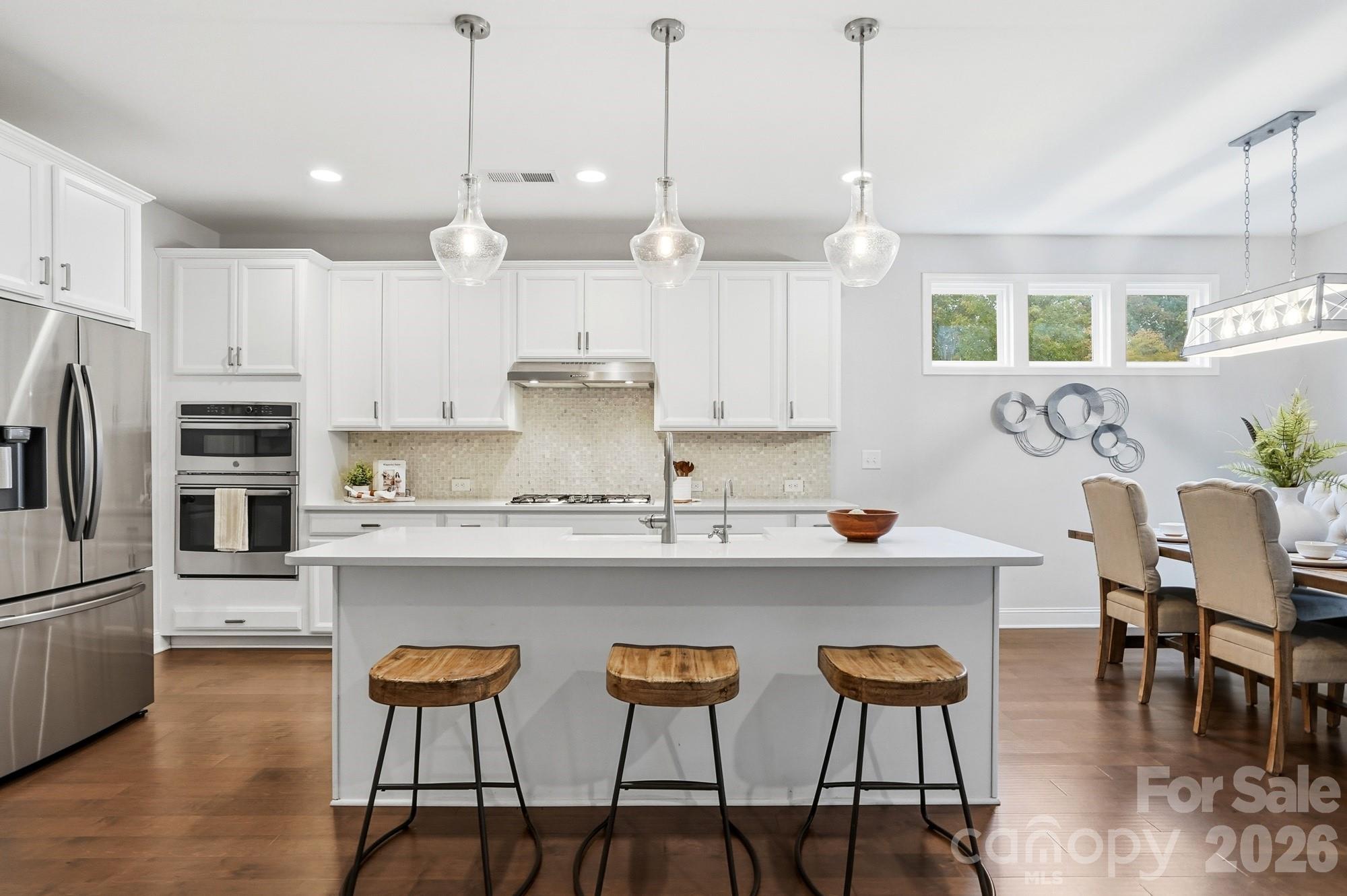 4044 Brandywine Terrace Lancaster, SC 29720 - Photo 12 of 48 a kitchen with kitchen island granite countertop a sink a center island and cabinets