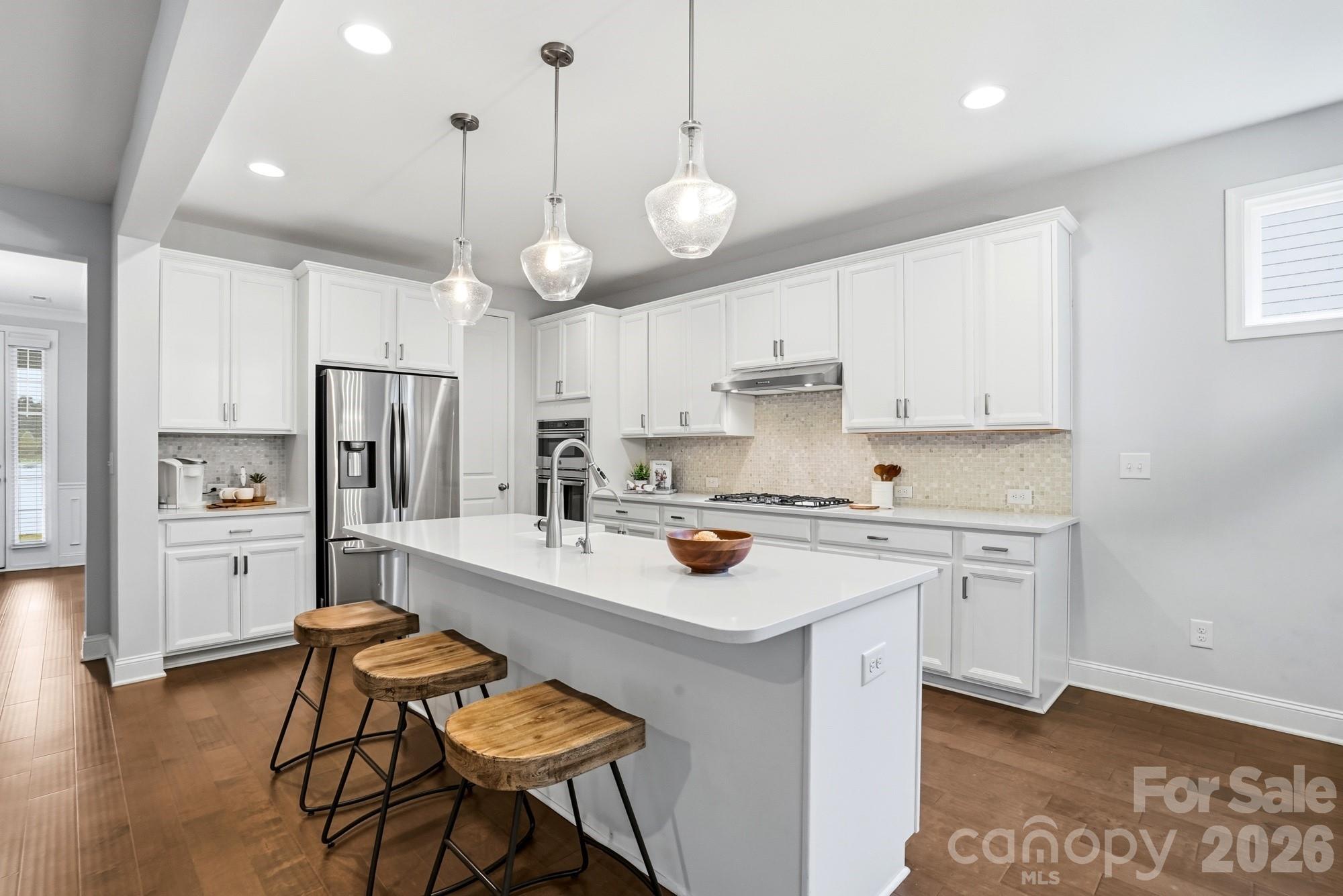 4044 Brandywine Terrace Lancaster, SC 29720 - Photo 13 of 48 a kitchen with a center island white cabinets and stainless steel appliances
