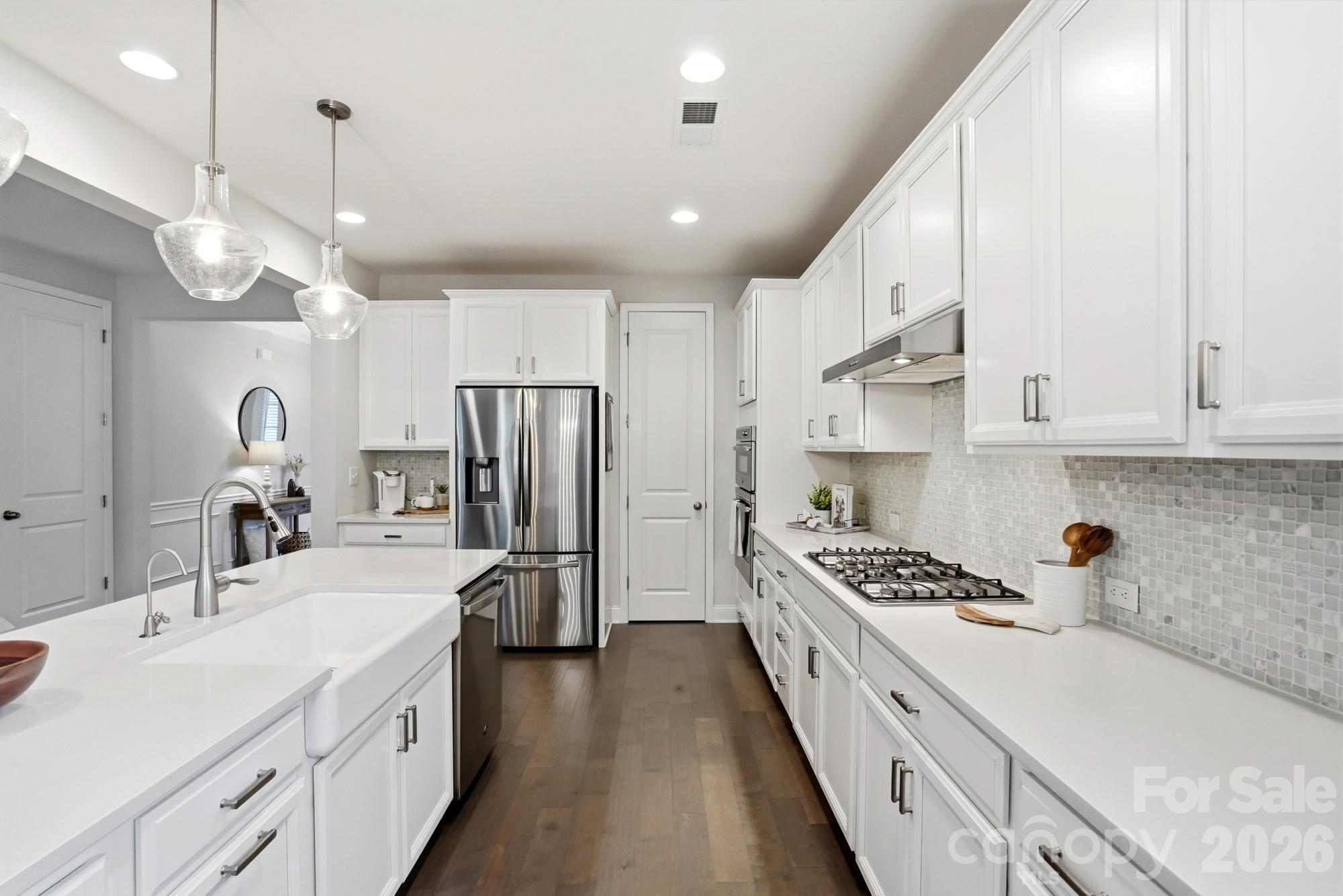 4044 Brandywine Terrace Lancaster, SC 29720 - Photo 16 of 48 a kitchen with kitchen island stainless steel appliances a sink cabinets and wooden floor