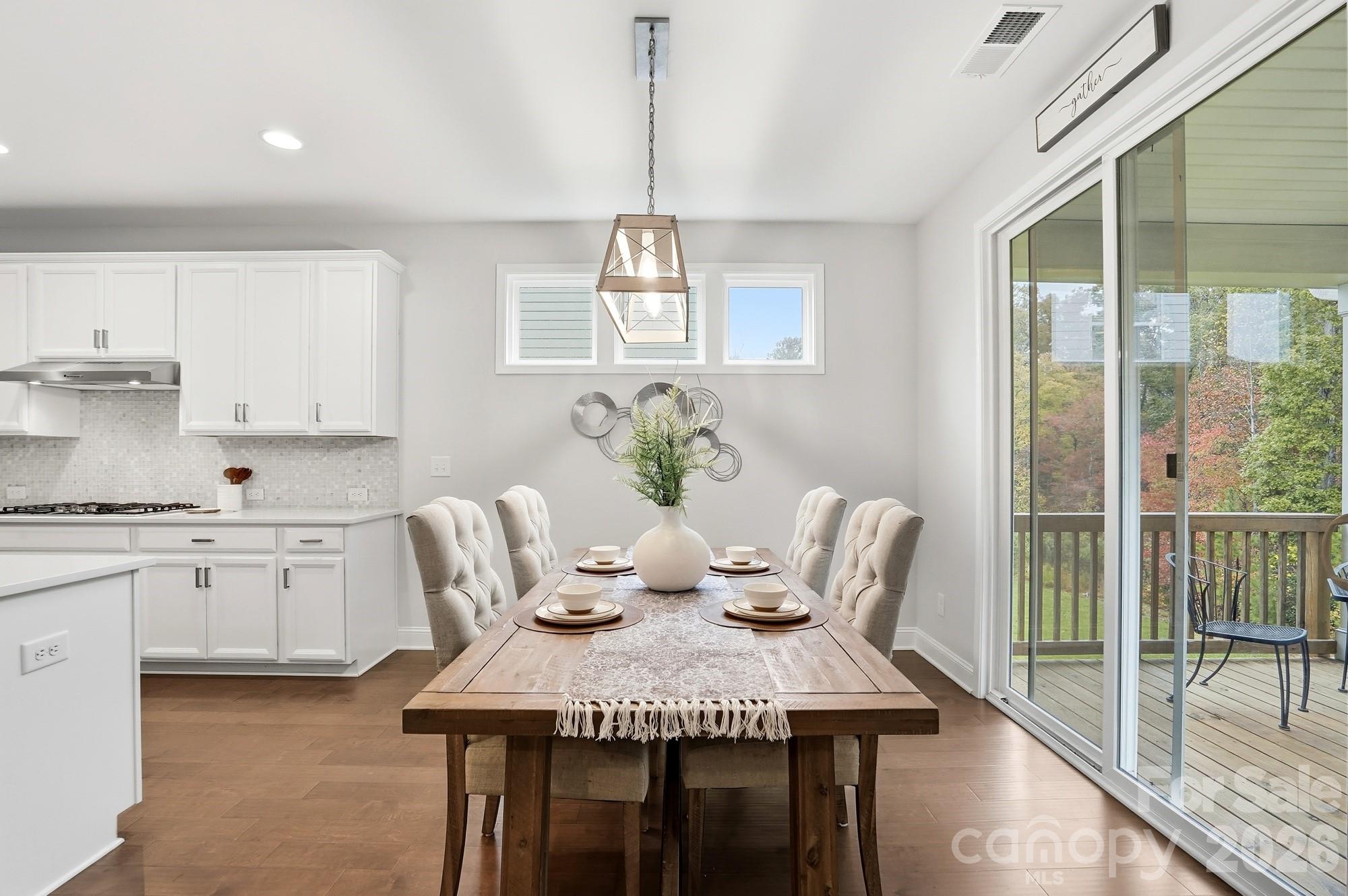 4044 Brandywine Terrace Lancaster, SC 29720 - Photo 22 of 48 a view of a dining room with furniture a chandelier and wooden floor