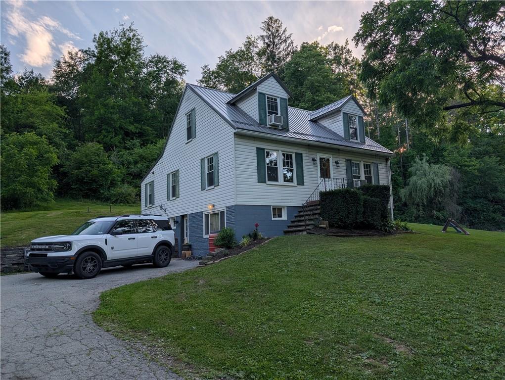 205 Woods Road Ligonier, PA 15658 - Photo 27 of 32 a front view of a house with a garden