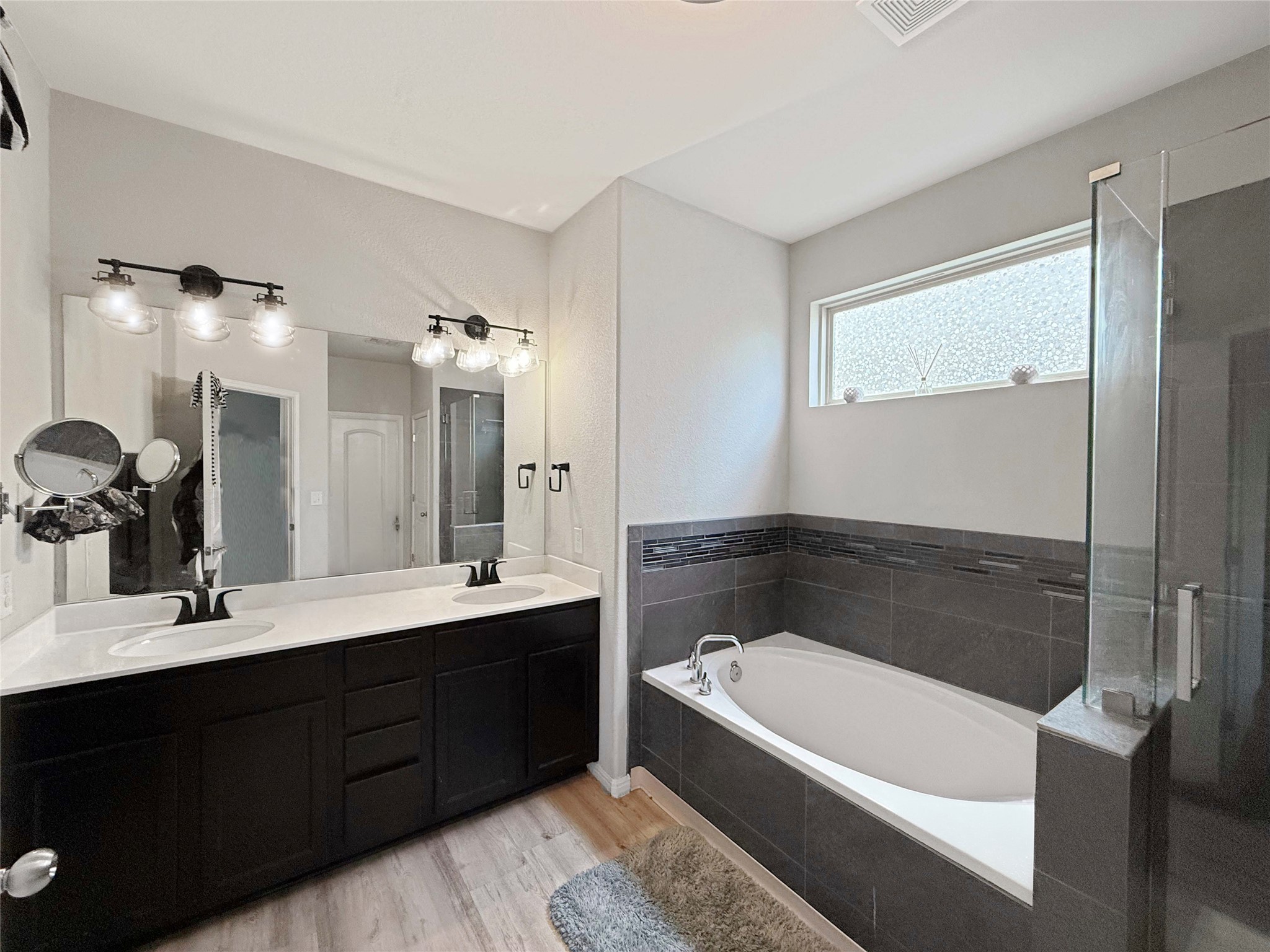 429 Rusk Bluff Avenue Leander, TX 78641 - Photo 9 of 24 Luxurious primary bath features dual vanity, a soaking tub, and a spacious walk-in shower.