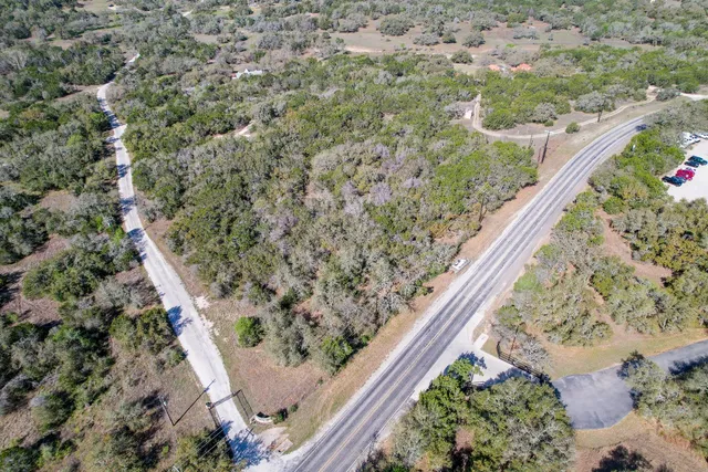 a view of a yard with a wooden fence