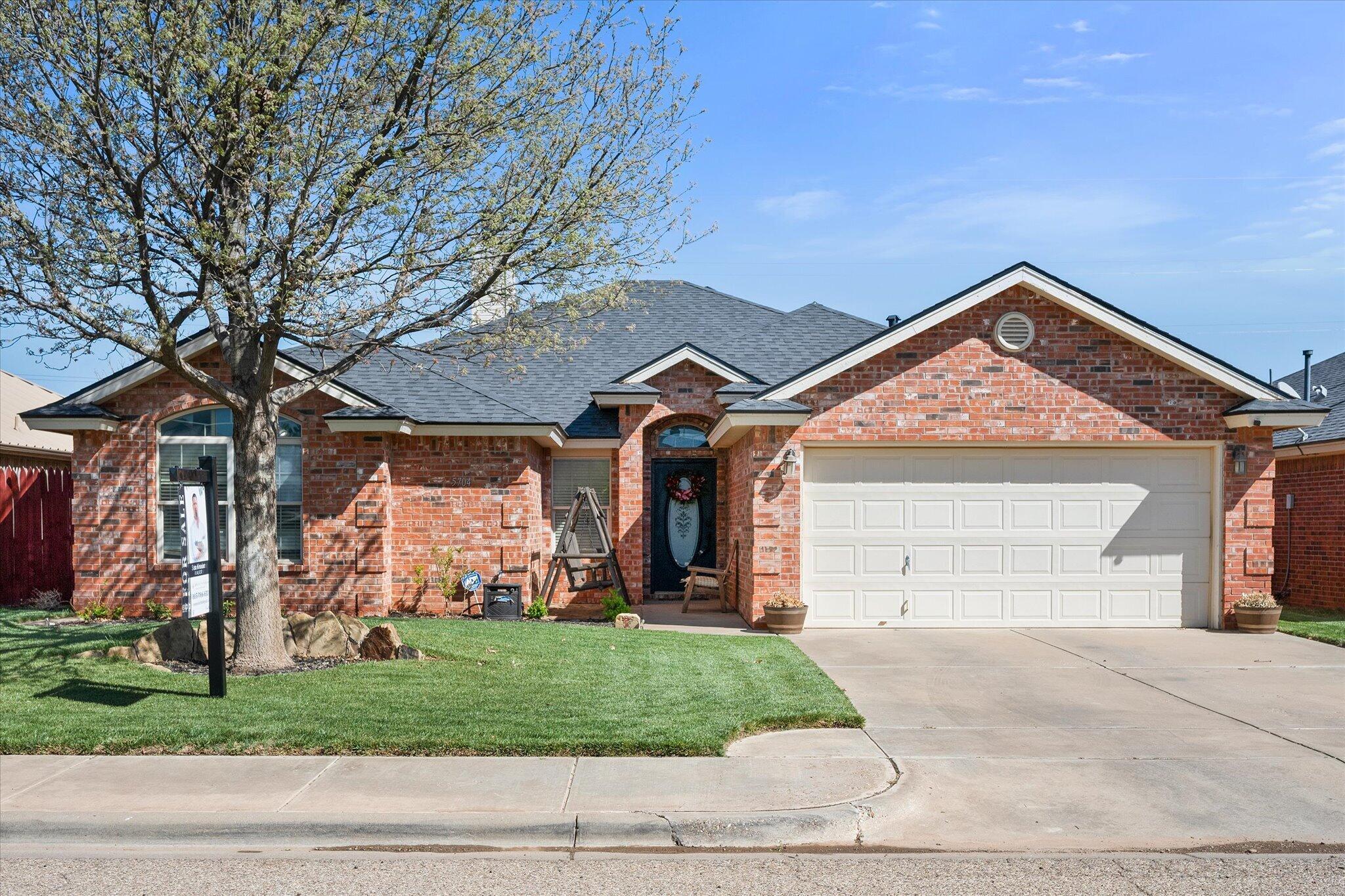 a front view of house with a garden