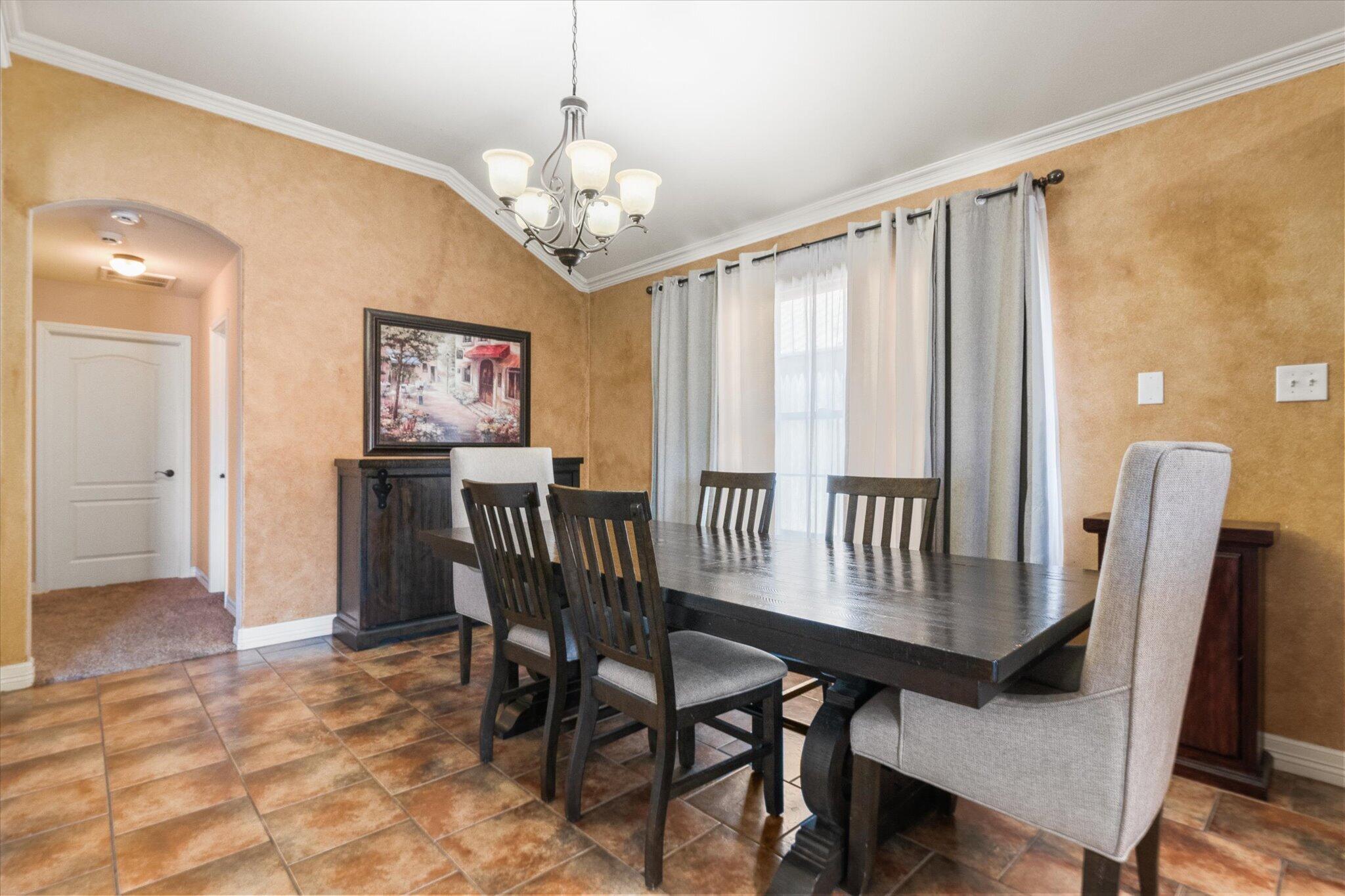 5704 107th Street Lubbock, TX 79424 - Photo 11 of 36 a view of a dining room with furniture window and wooden floor