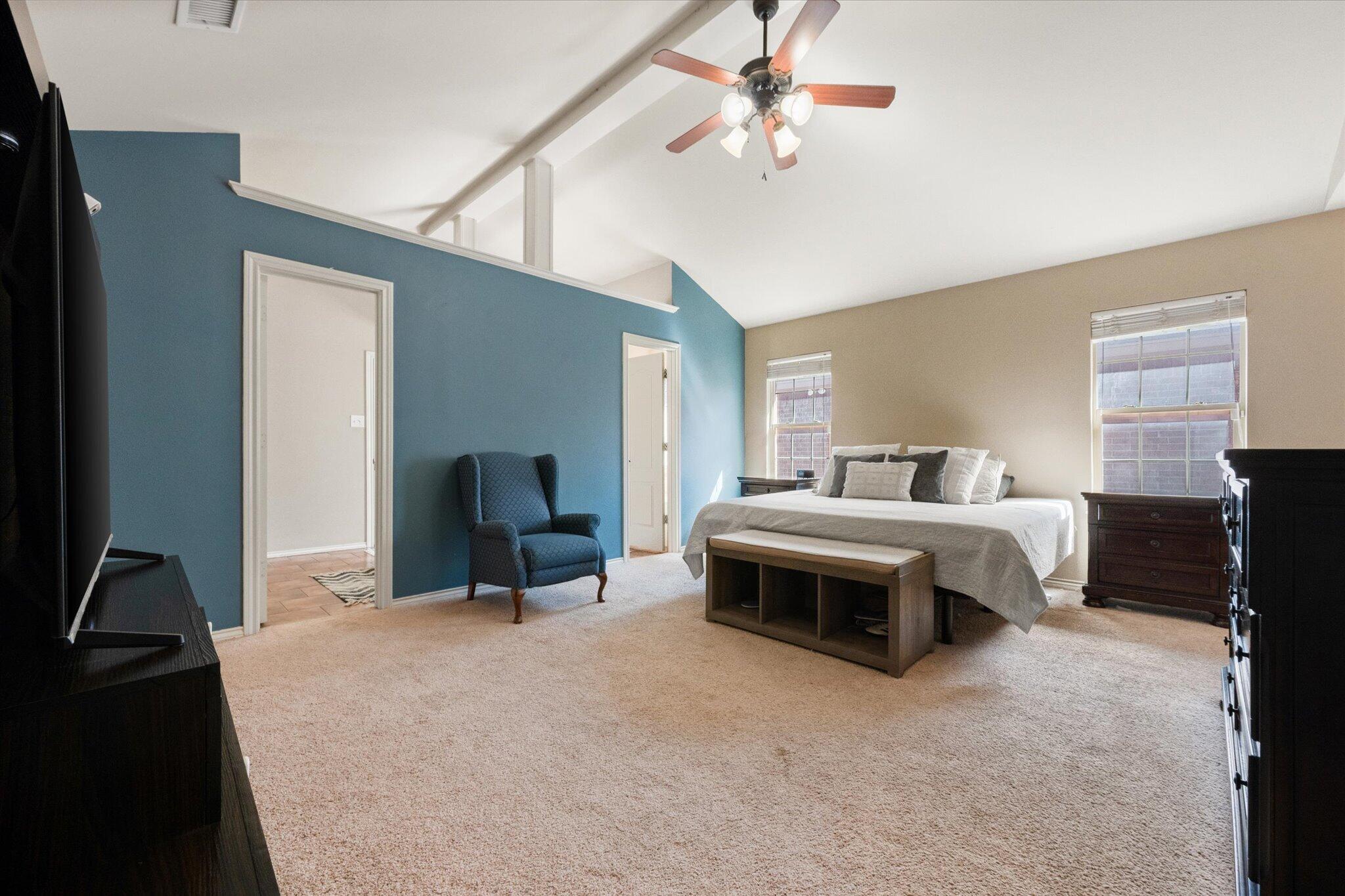 5704 107th Street Lubbock, TX 79424 - Photo 19 of 36 a bedroom with a bed and a chandelier