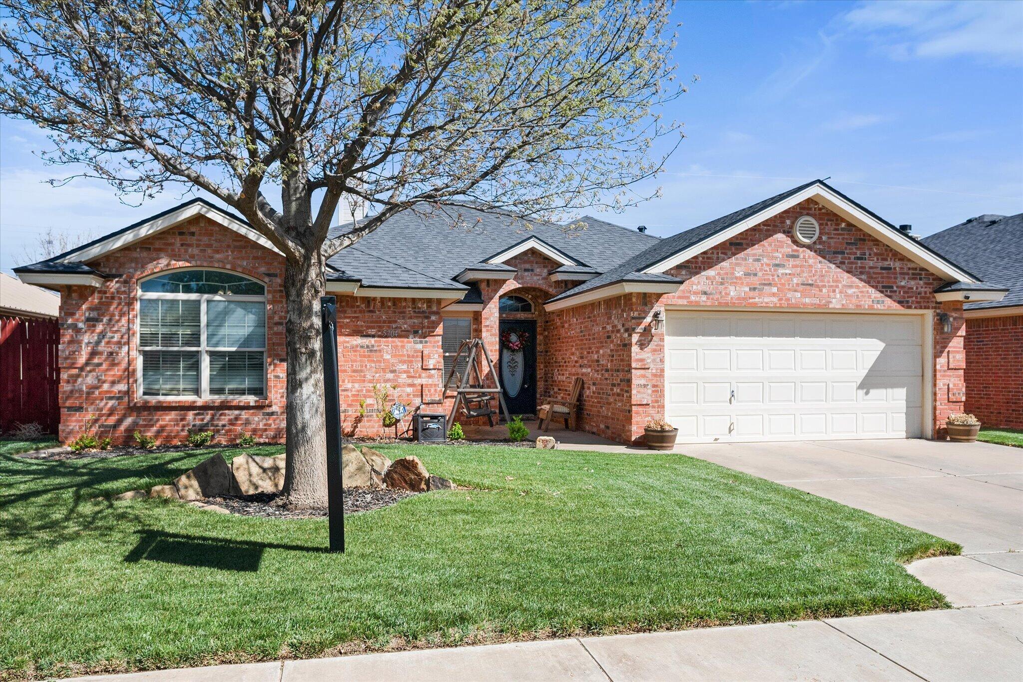 5704 107th Street Lubbock, TX 79424 - Photo 2 of 36 front view of a house with a yard