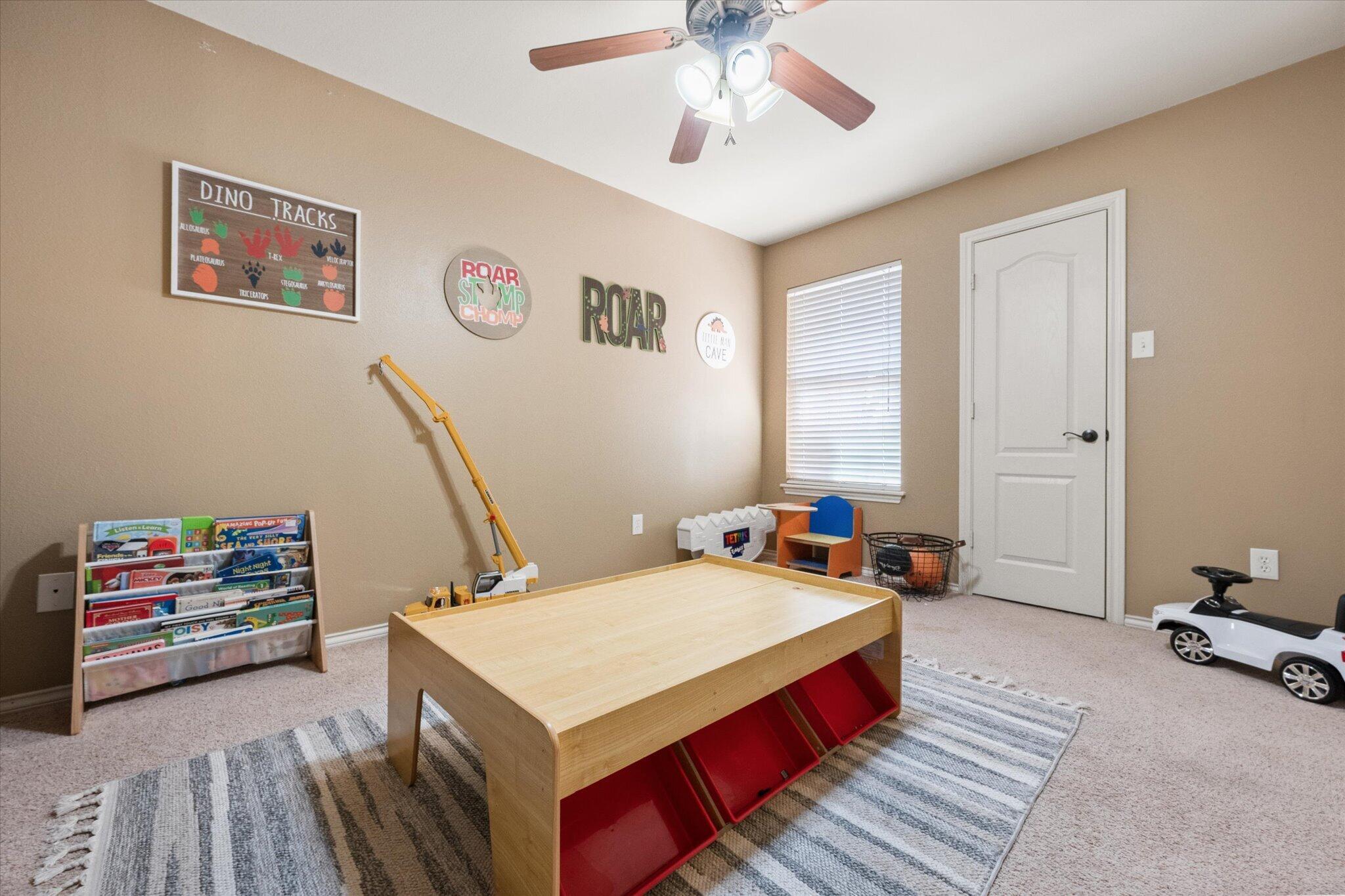 5704 107th Street Lubbock, TX 79424 - Photo 30 of 36 a bed room with a bed and a couch