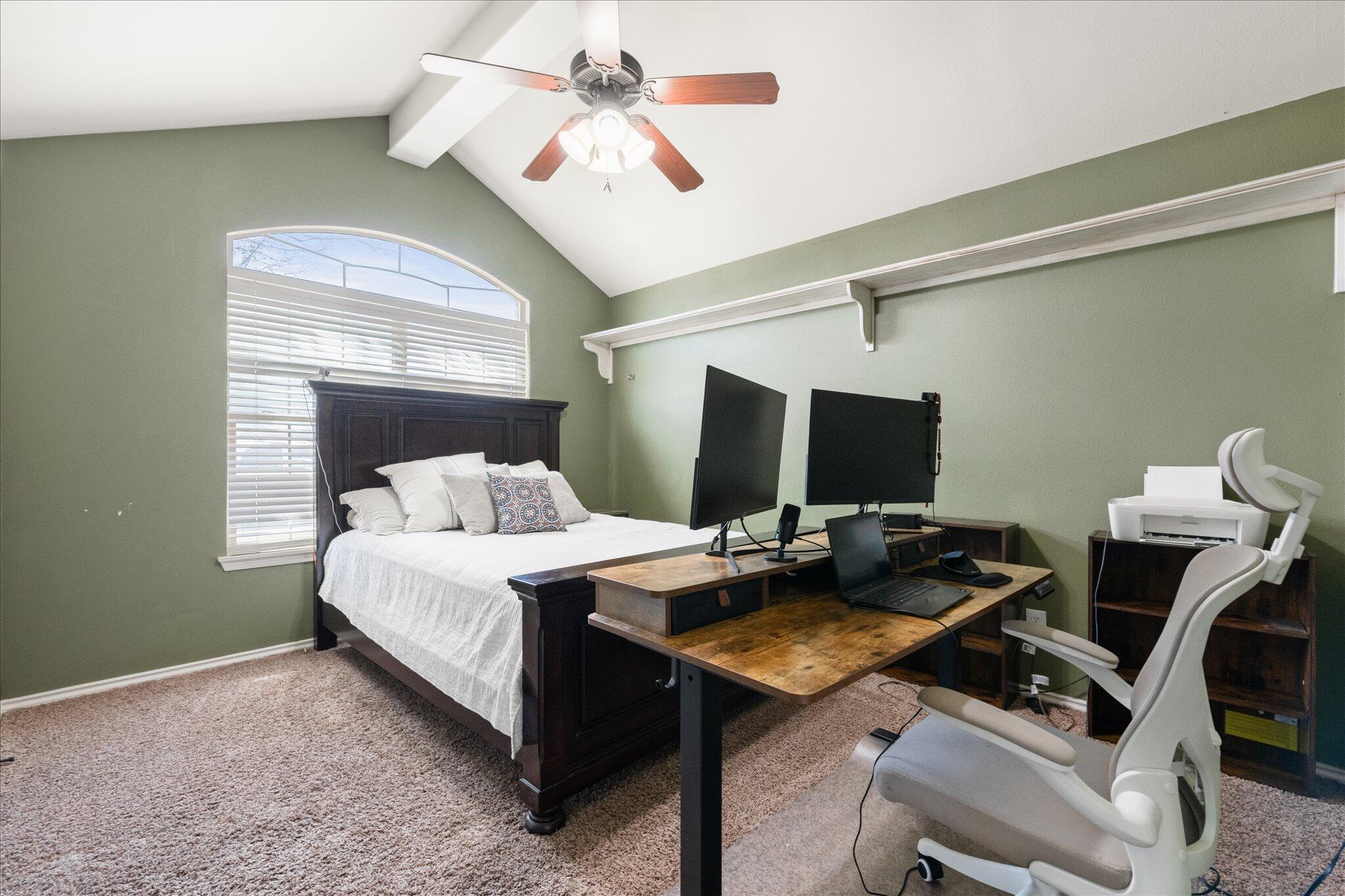 5704 107th Street Lubbock, TX 79424 - Photo 32 of 36 a bedroom with a bed and a table