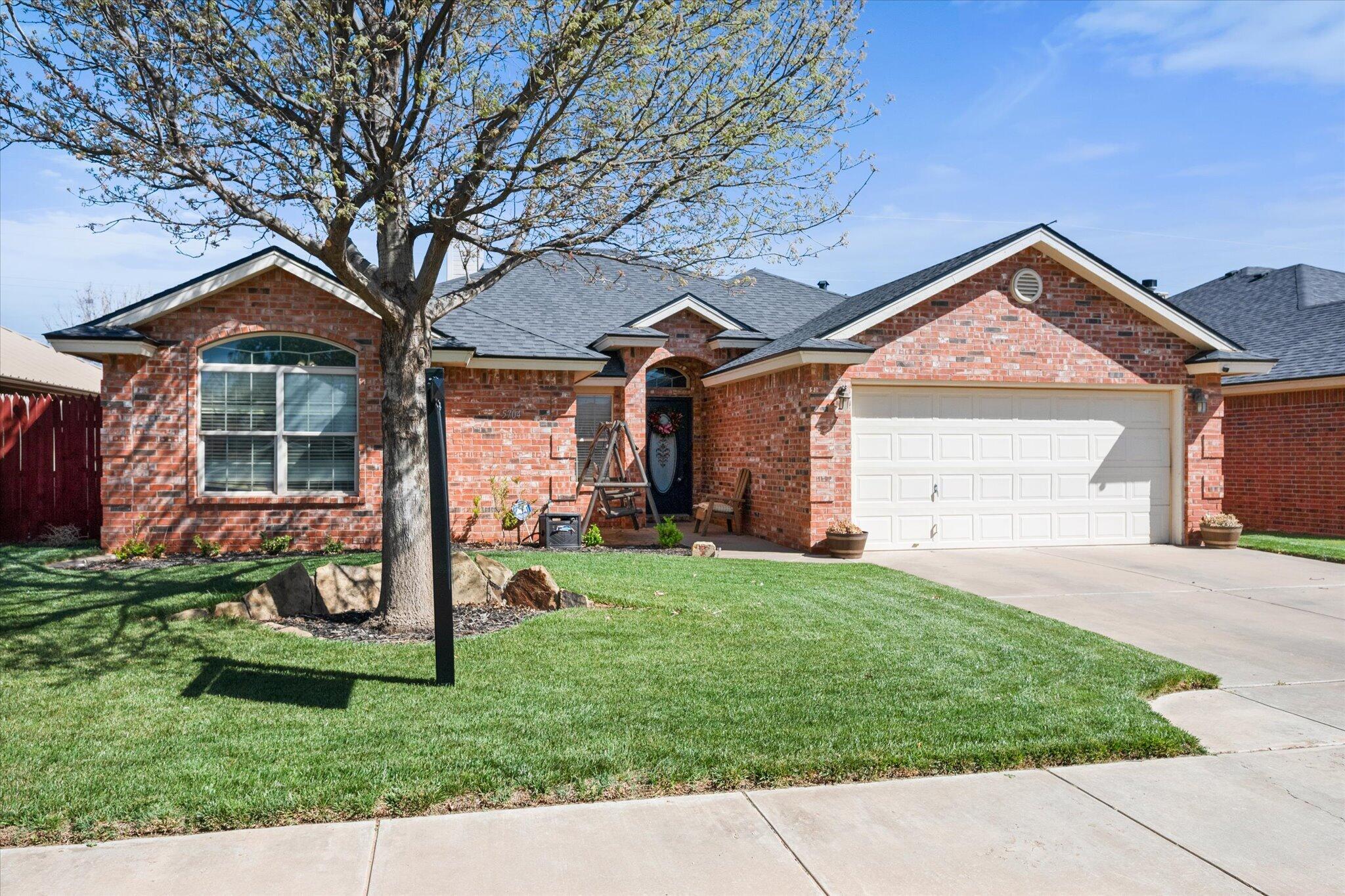 5704 107th Street Lubbock, TX 79424 - Photo 4 of 36 front view of a house with a yard
